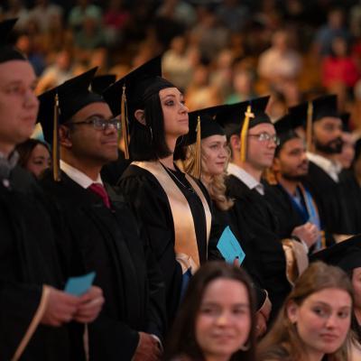 Graduates stand ready to receive their diploma 